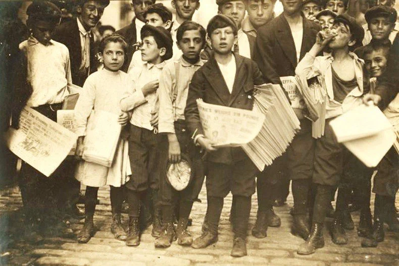 Newsboys posing with newspapers in New York City during the newspaper era