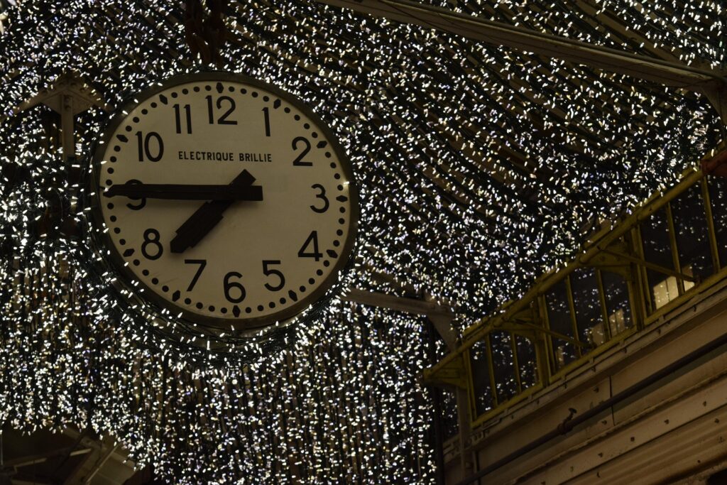 Historic clock and decorative lighting inside Chelsea Market